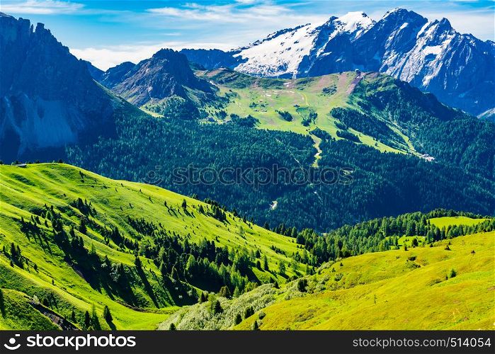 View of the Italian Alps Mountain the Dolomites with the snow the small village and the green hill in South Tyrol, Italy