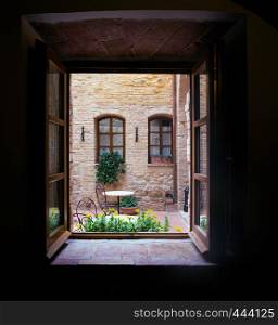 View of the Italian courtyard through the window, italy