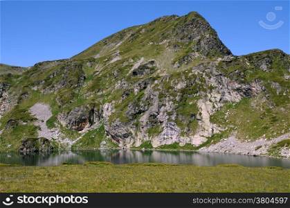 View of the Kidney glacial lake and the mountain in the Seven Rila Lakes National park in Bulgaria