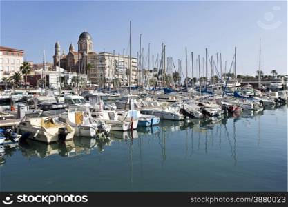 View of the Mediterranean Coast village of Saint-Raphael. Behind, the dome and the bell towers of the Basilica of Our Lady of Victory of Lepanto