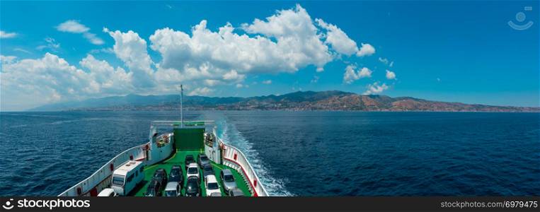 View of the Messina sea strait and coastline from the side of the ferry to Sicily island, Italy.