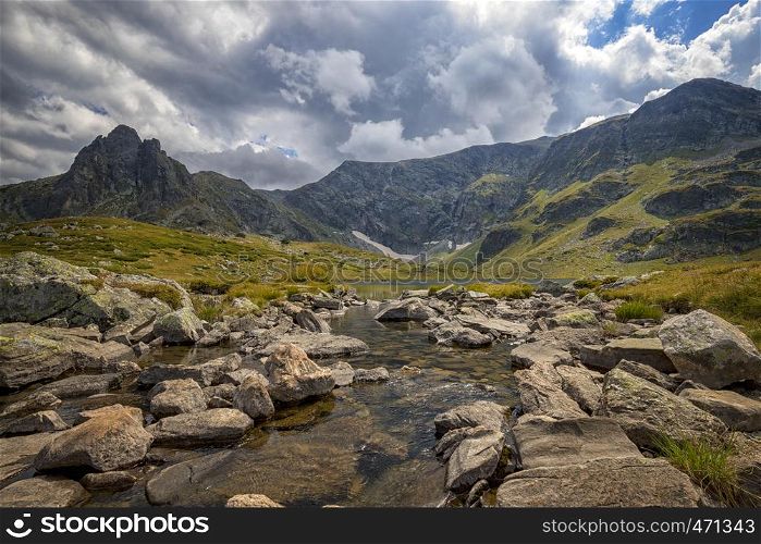 View of the mountains with rocks. A mountain river among stones and rocks.