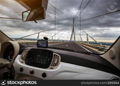 view of The Normandy Bridge in France across the river Seine from the car window. Pont de Normandie
