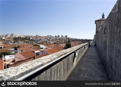 View of the north side of the top of the Aqueduct of the Free Waters looking to the city of Lisbon, Portugal