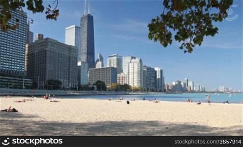 View of the Northern Chicago skyline and Lake Michigan from the sandy beach near Navy Pier on a sunny day