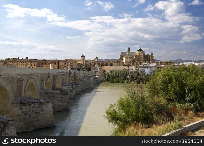 View of the old city and Mosque-Cathedral of Cordoba seen from the south bank of the Guadalquivir river in Spain.