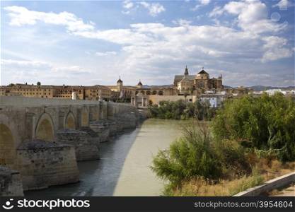View of the old city and Mosque-Cathedral of Cordoba seen from the south bank of the Guadalquivir river in Spain.