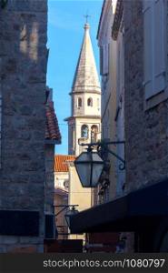 View of the old city street and the bell tower. Budva. Montenegro. Budva. Old city street.