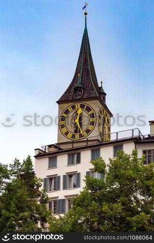 View of the old medieval clock tower in sunset lighting. Zurich. Switzerland.. Zurich. Old medieval tower with a city clock.