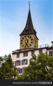 View of the old medieval clock tower in sunset lighting. Zurich. Switzerland.. Zurich. Old medieval tower with a city clock.
