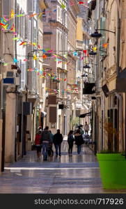 View of the old medieval narrow street on a sunny day. Avignon. Provence. France.. Avignon. Old medieval narrow street in sunny day.