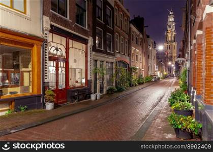 View of the old medieval street and the Westerkerk bell tower. Amsterdam. Netherlands.. Night street in Amsterdam against the background of the Westerkerk tower.