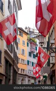 View of the old narrow medieval city street with lanterns. Zurich. Switzerland.. Zurich. Narrow street of the old city on a sunny day.