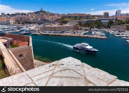 View of the old port from the fort of St. John on a sunny day. Marseilles. France.. Marseilles. View of the water area of the old harbor on a sunny day.