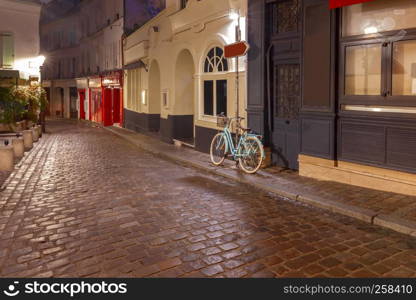 View of the old street on the Montmartre hill in the night lighting. Paris. France.. Paris. Old street on the Montmartre hill.
