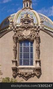 View of the ornate California Dome and decorated window from the Gardens in Balboa Park in San Diego