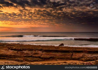View of the Pedra Branca beach in Ericeira village, Portugal on late afternoon.