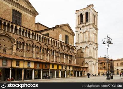 View of the Piazza Trento e Trieste and the cathedral Campanile (bell tower), with locals and tourists, in Ferrara, Italy