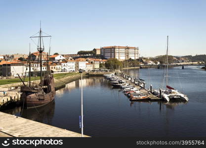 View of the river mouth marina with the replica of a sixteenth century caravel on the left, in Vila do Conde, Portugal
