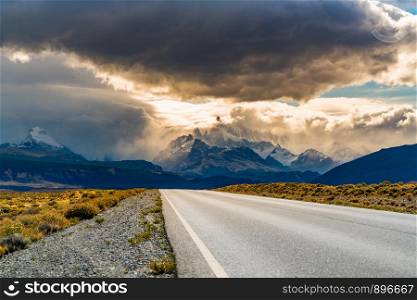 View of the road to El Chalten with Mount Fitz Roy in the mist and rain clouds in the sky at Argentina Patagonia