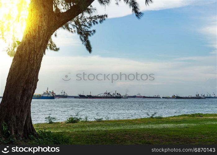 View of the sea from East Coast Park in Singapore under the beautiful blue sky cloudy with Sun flare