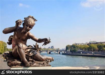 View of the Seine from Pont Alexandre III framed by small impish statue