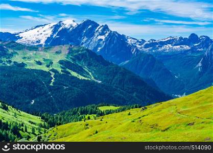 View of the snow covered Dolomites Mountain in summer with the ski lift and small village at the valley in South Tyrol, Italy