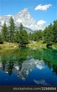 View of the south face of Matterhorn reflected in a small lake, Italy