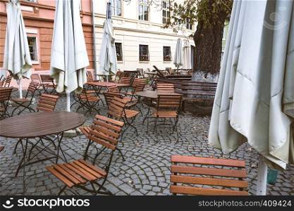 view of the street cafe on the main square in the historic city center Sighisoara illuminated by the street lamps.