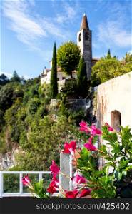 view of the tower and flowers in the foreground at the famous small town Tremosine, Italy.