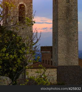 View of the towers the old town San Gimignano at the province of Siena in evening time. Tuscany, Italy