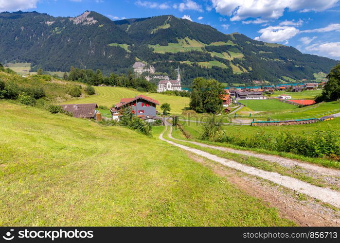 View of the traditional medieval alpine village on a sunny day. Lungern Switzerland.. Lungern Old medieval village in the swiss alps.