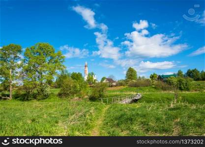 View of the village of Mikhailovskoye with views of the Church of the Holy Archangel Michael and the bodiless hosts on a Sunny spring day.