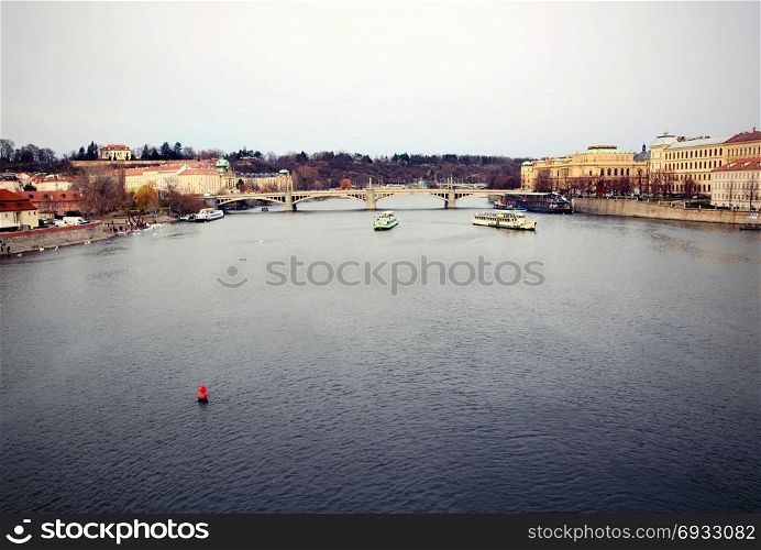 View of the Vltava river and Prague Castle above in old Prague town center.