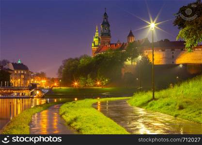 View of the walls and towers of the Wawel Castle in night lighting. Poland. Krakow.. Krakow. The facade of the famous Wawel Castle in night lighting.