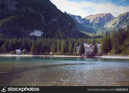 view of the well-known tyrolean lake lago di Braies and the hotel on the beach, Dolomites. Italy