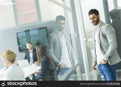 View of the young businessman standing in the office
