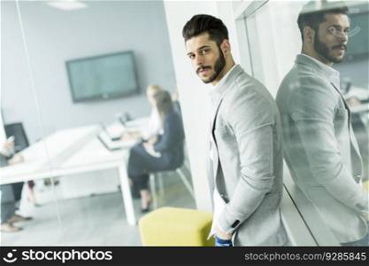 View of the young businessman standing in the office