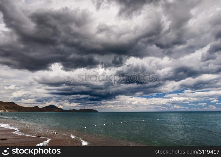 View of thunderstorm clouds above the sea