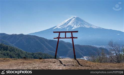 View of Torii gate of Asama Shrine with Mount Fuji in background.