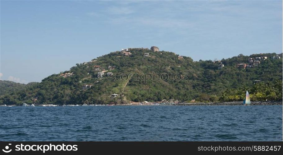 View of town on hillside along coastline, Zihuatanejo, Guerrero, Mexico