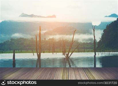 view of tropical lake and mountains with platform, Thailand