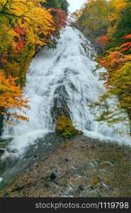 View of Udaki falls in the forest of colorful foliage of autumn season on the mountain at Nikko City, Tochigi Prefecture, Japan.