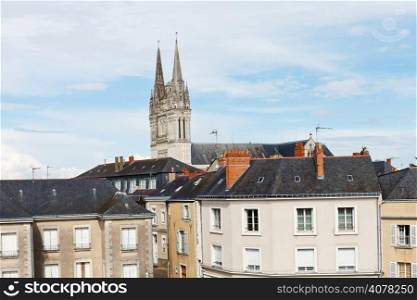 view of urban houses and Saint Maurice Cathedral in Angers, France