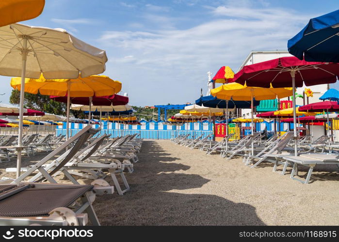 view of Varazze beach and its typical colored sun umbrellas, the parasols are arranged in rows