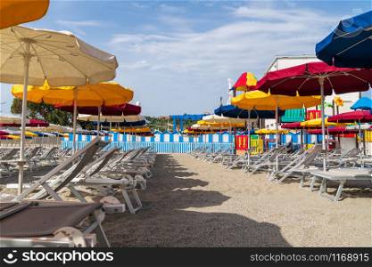 view of Varazze beach and its typical colored sun umbrellas, the parasols are arranged in rows