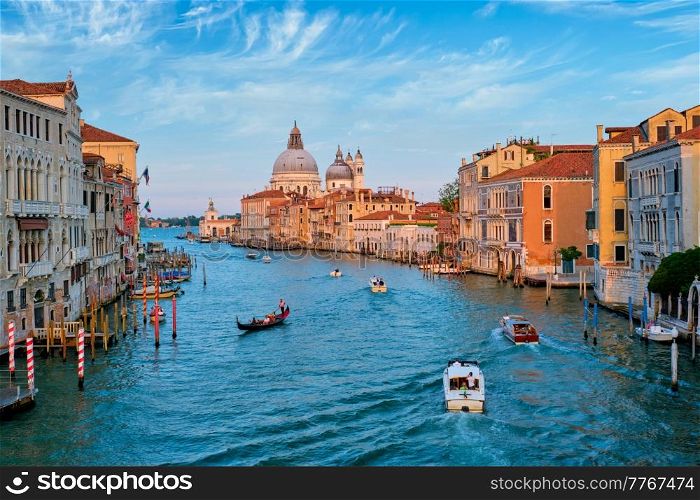 View of Venice Grand Canal with boats and Santa Maria della Salute church on sunset from Ponte dell&rsquo;Accademia bridge. Venice, Italy. View of Venice Grand Canal and Santa Maria della Salute church on sunset