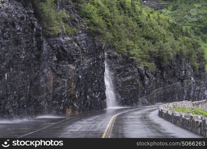 View of waterfall on a mountain road, Going-to-the-Sun Road, Glacier National Park, Glacier County, Montana, USA