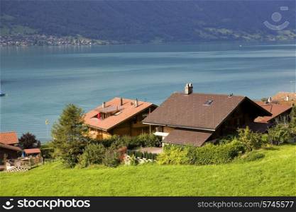 View of wooden cabins with a lake and mountain at switzerland