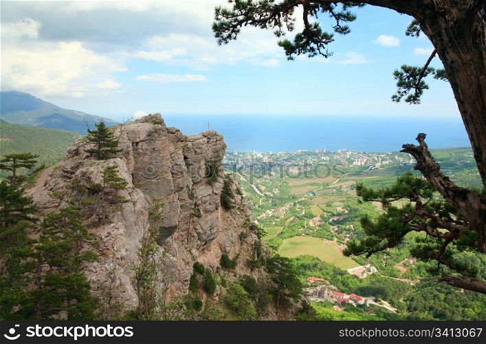 View of Yalta city from slope of Aj-Petri Mount and cross on rock (Botanical trail , Crimea, Ukraine)